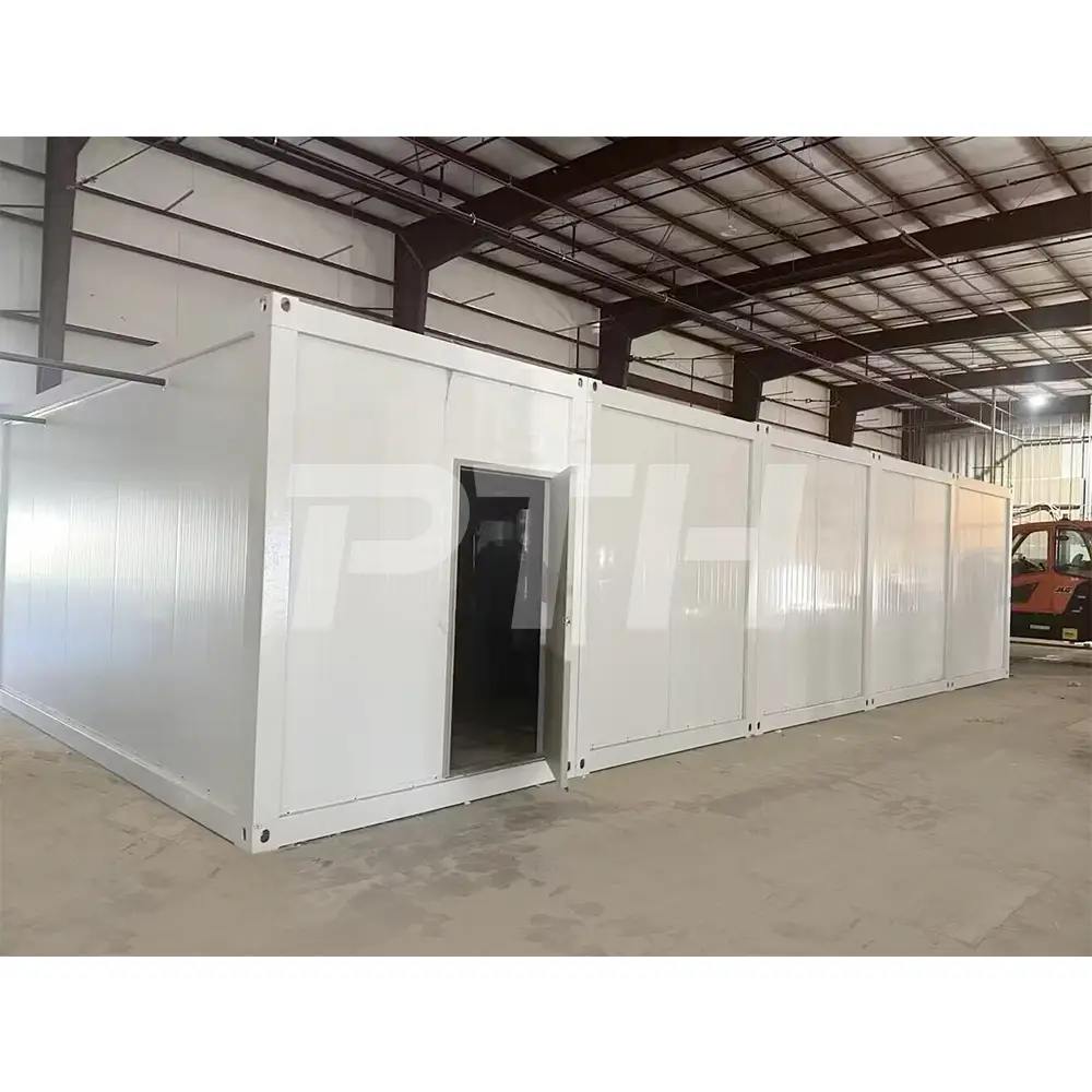White prefabricated modular unit with open entrance in warehouse facility.