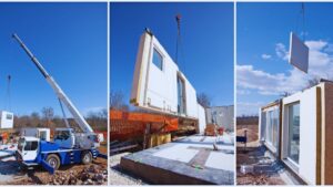 Crane lifting and placing prefabricated modular home sections with large windows onto foundation in sequence. Modern prefab house construction.