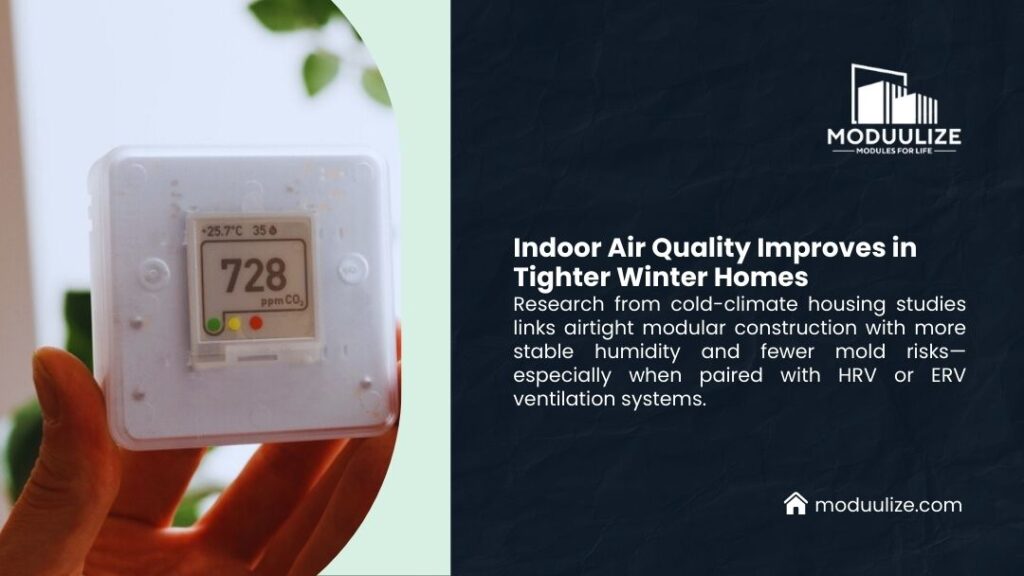 Hand holding air quality monitor displaying CO2 and humidity readings, illustrating how airtight modular construction with HRV ventilation improves indoor air quality